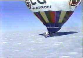 A hot air balloon lands on the ice.