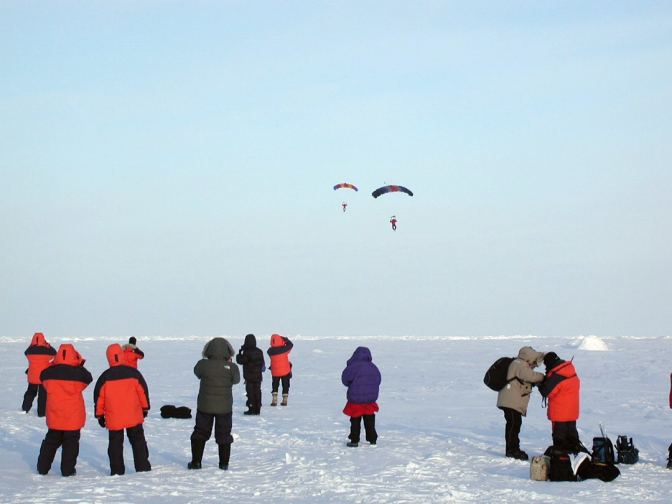 Picture of two parachutes coming for landing.