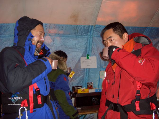 Ski team members relax in the cafeteria tent before leaving for the North Pole