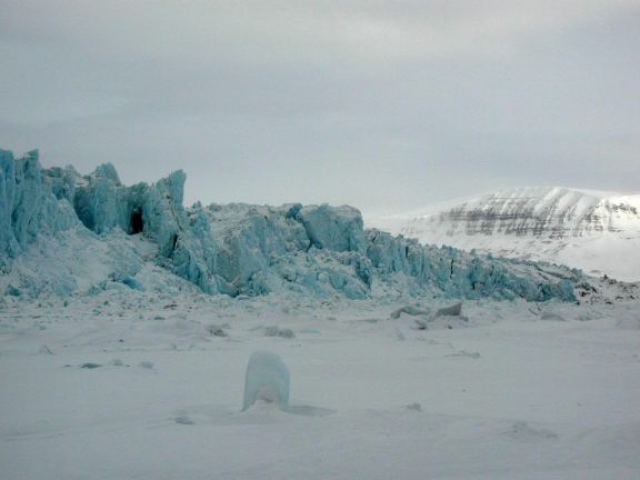 Glacier picture with mountains in background.