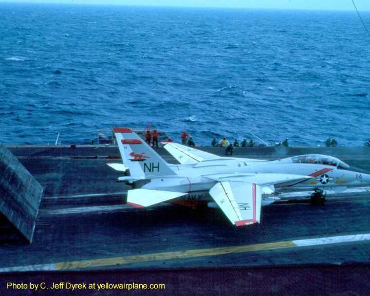 a grumman f14 tomcat runs up to the cats of the aircraft carrier, uss kitty hawk