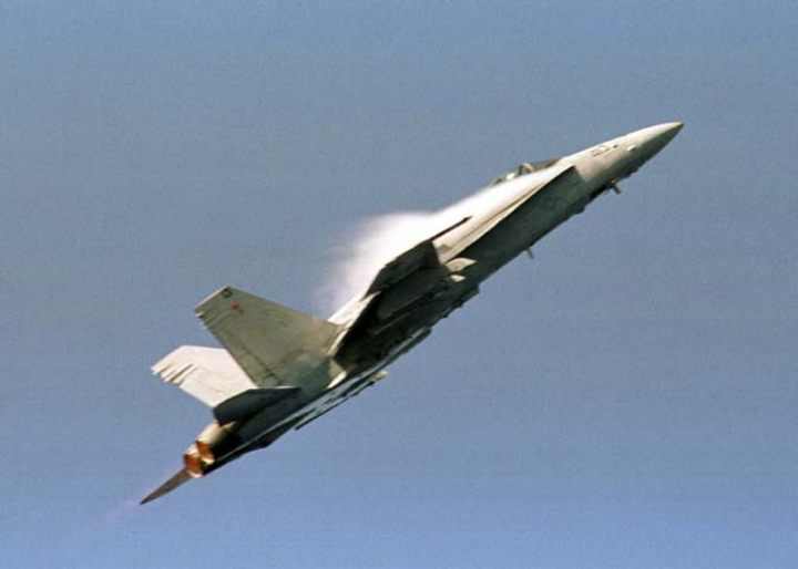 An f18  hornet creates clouds when it pulls up real hard